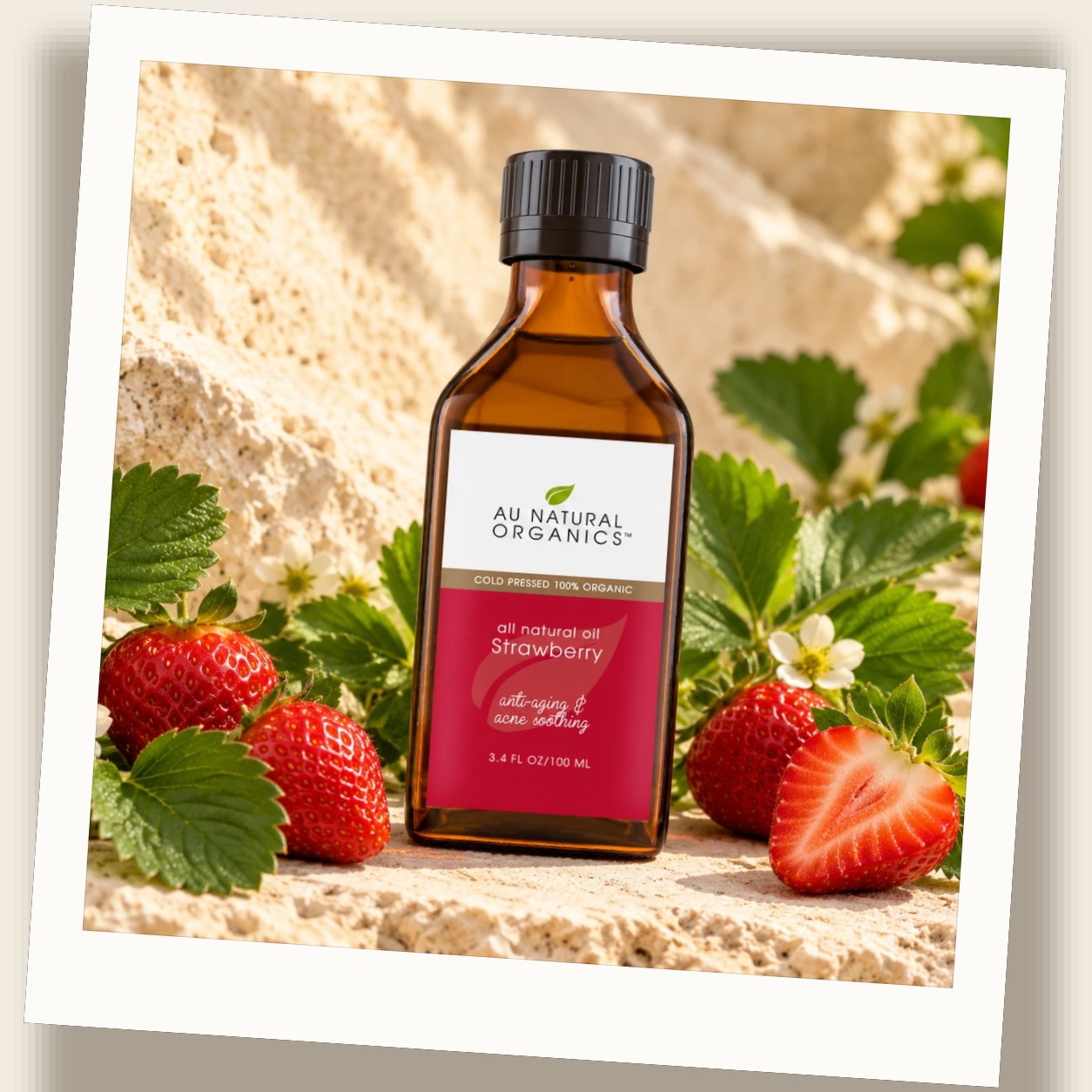 Au Natural Organics Strawberry Seed Oil bottle with fresh strawberries on stone